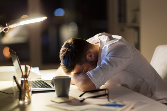 poor sleep hygiene: Man sleeping on his desk