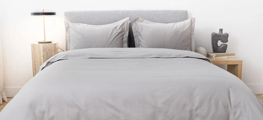 Light grey duvet cover on bed 