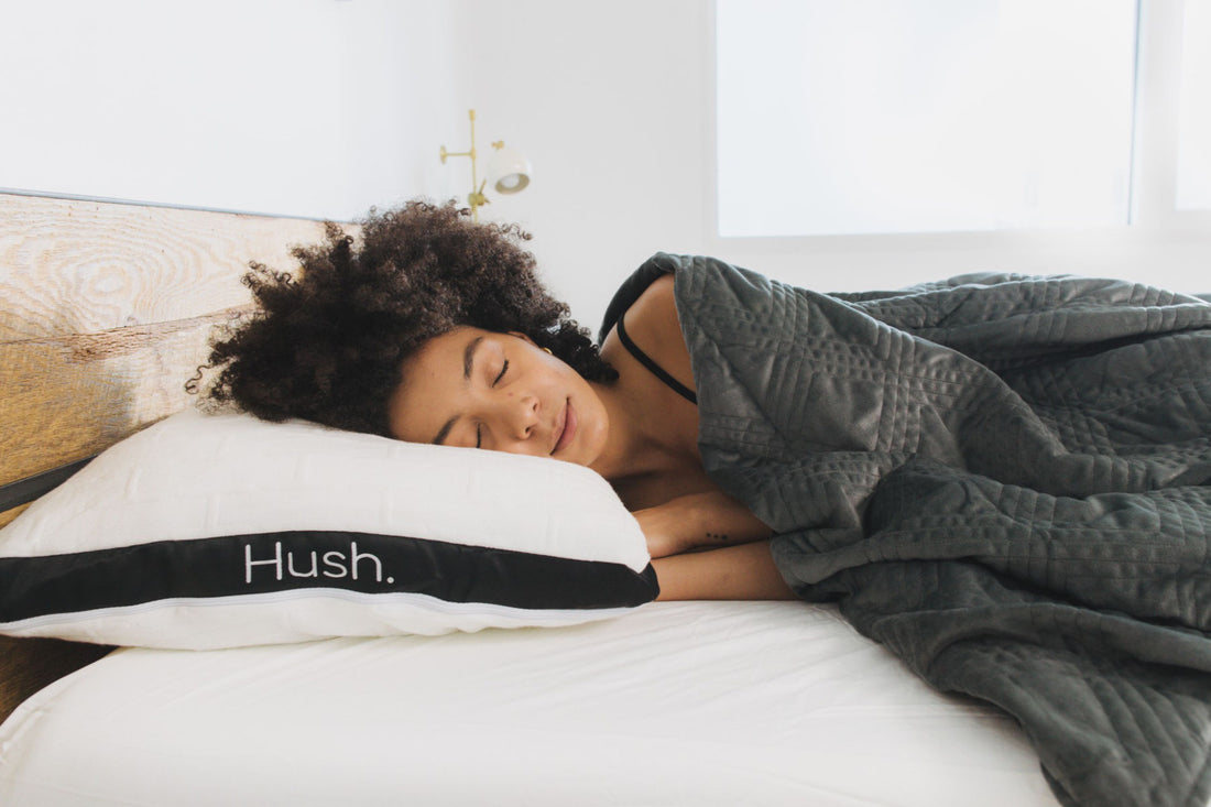 A woman sleeps soundly on the Hush mattress.