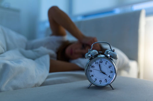 How long does it take to fall asleep: Woman lying awake in bed