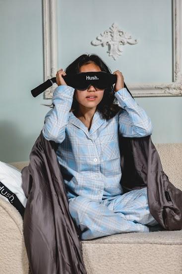 woman putting on a sleep mask