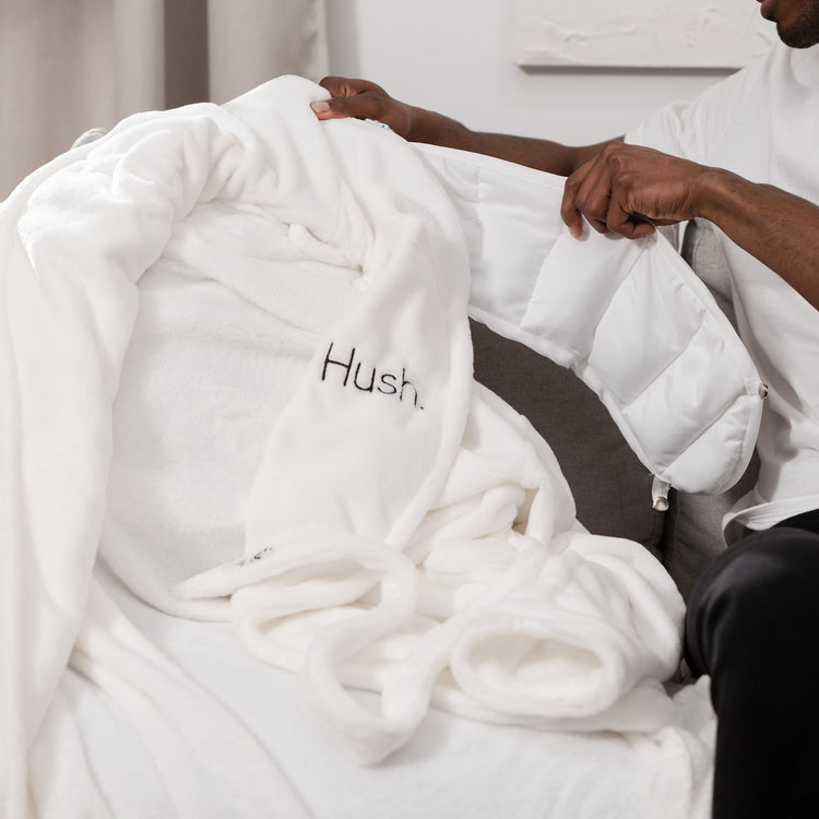 Man pulling neck weight out of Hush Robe