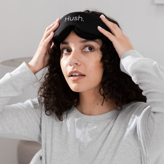 Woman looking up with Hush Blackout Eye Mask on forehead